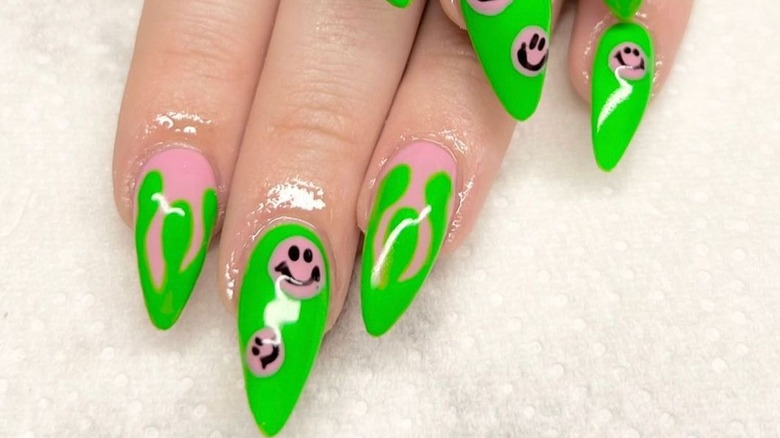 Woman wearing slime designs on her nails