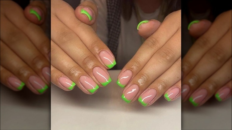 Woman wearing green French tips