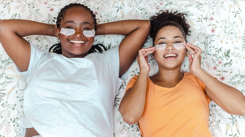 Two women wearing under eye masks