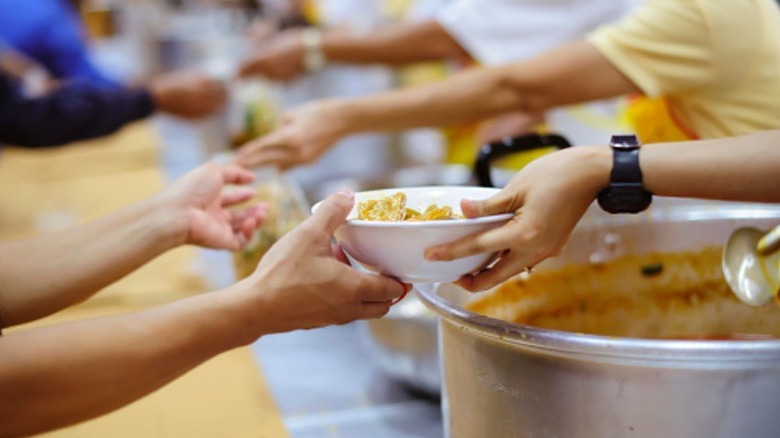 Handing someone bowl of soup