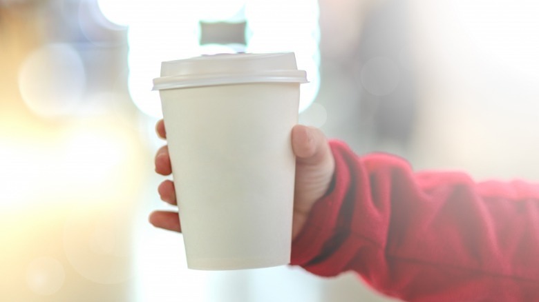 Hand holding cup of coffee