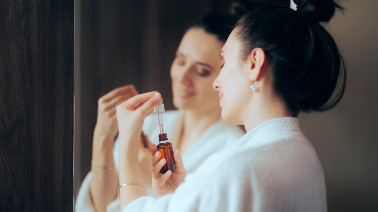 woman looking at skin serum 