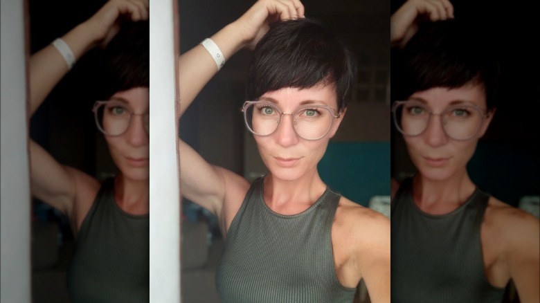 Woman with ashy brown pixie cut