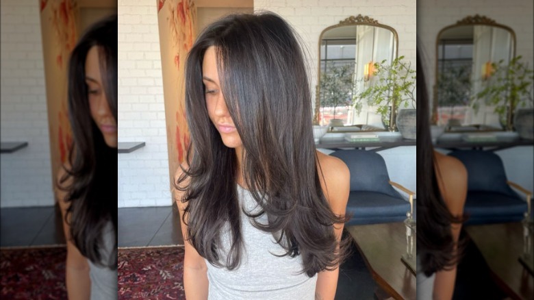 Woman with ashy brown layered hair