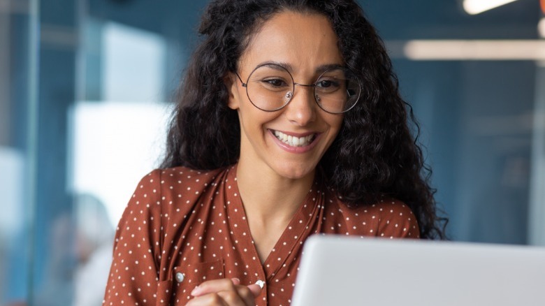 Woman smiling at her computer