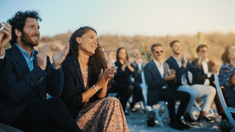 Wedding guests smiling and clapping