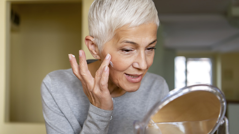 Woman applying anti-aging product 