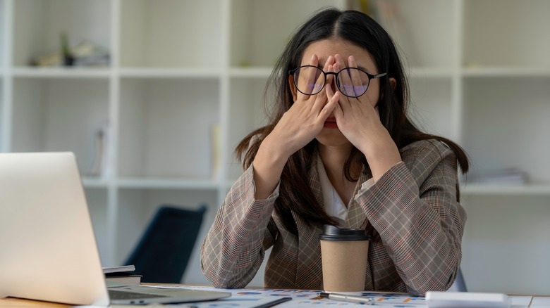 person stressed; covering face