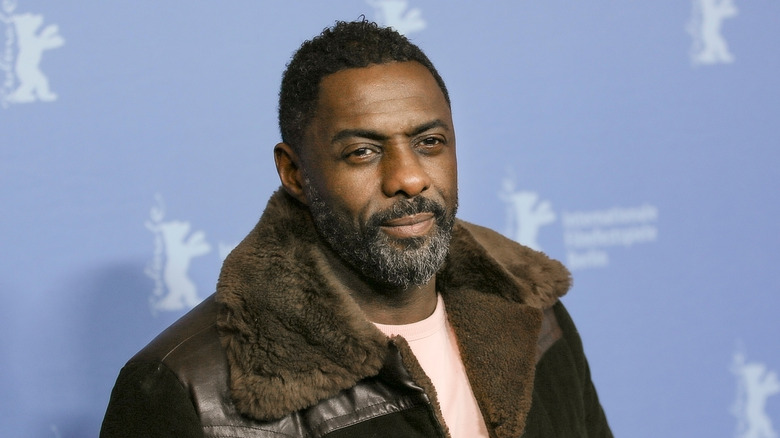 idris elba in coat and T shirt