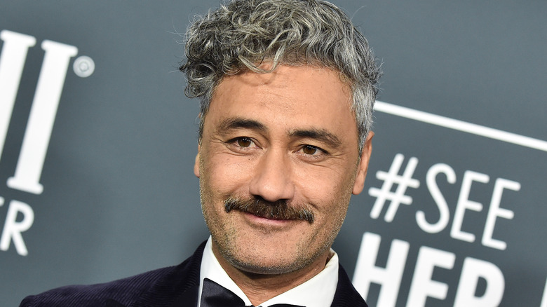 taika watiti with closed-mouth smile