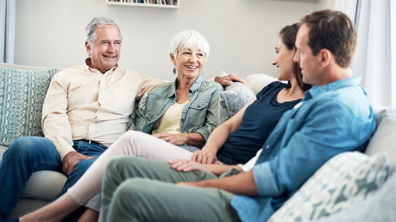 Young couple talking with parents