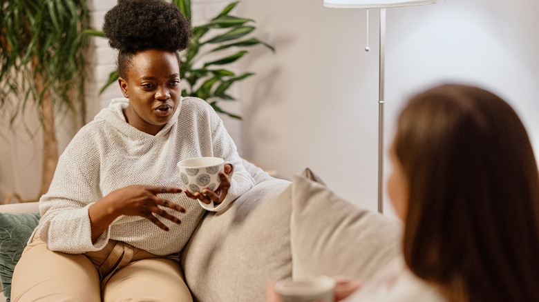 two friends talking on sofa