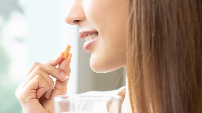 woman taking medicine