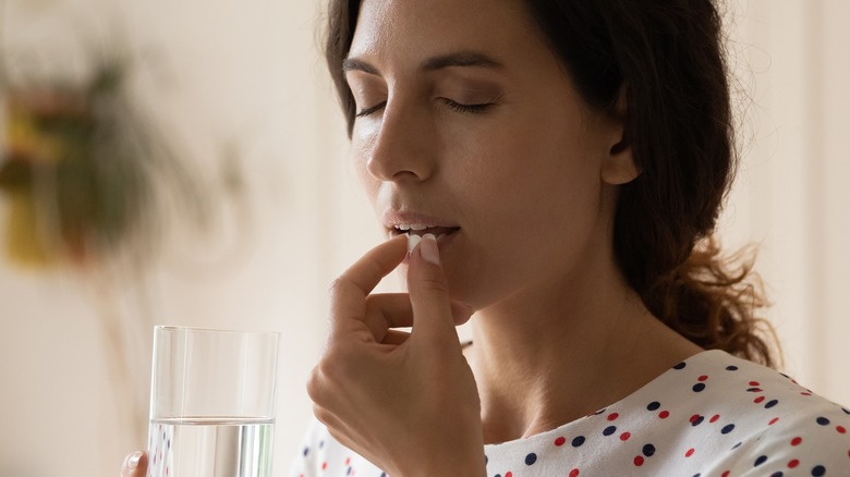 woman taking pill