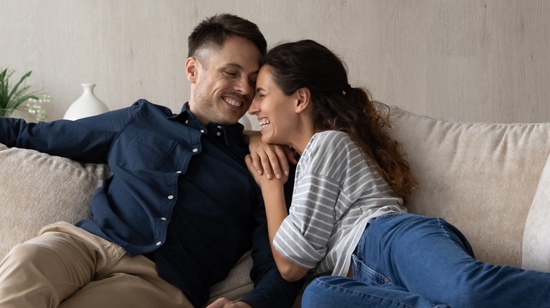 couple smiling on sofa 