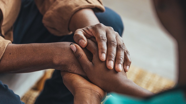 couple holding hands 