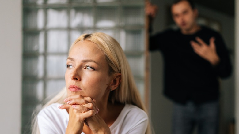 woman thinking with man behind her