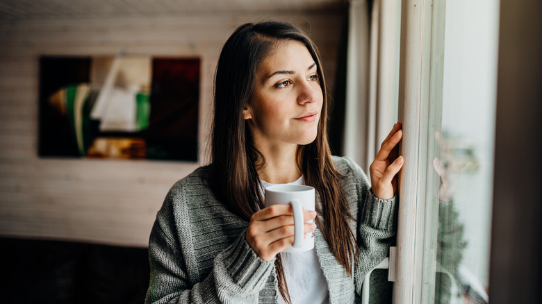 Woman looking out window 