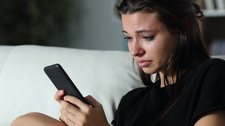 crying woman with phone