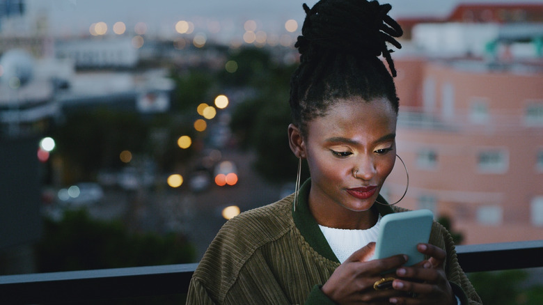 woman in city using phone