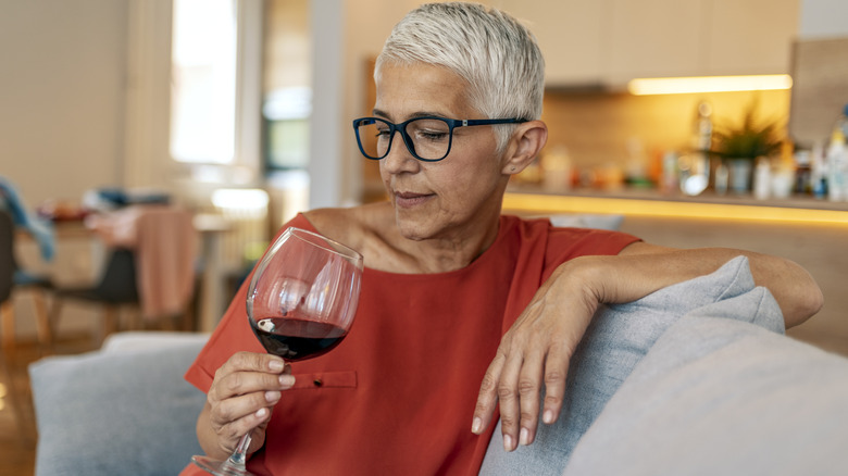 Woman examines glass of wine