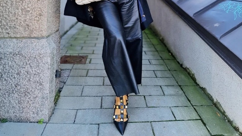 Woman wearing studded Valentino heels.