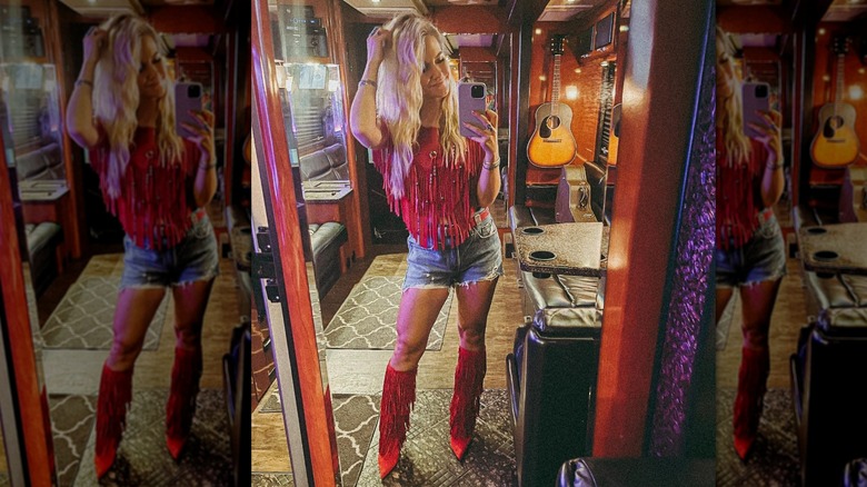 Blond wearing fringe top, boots