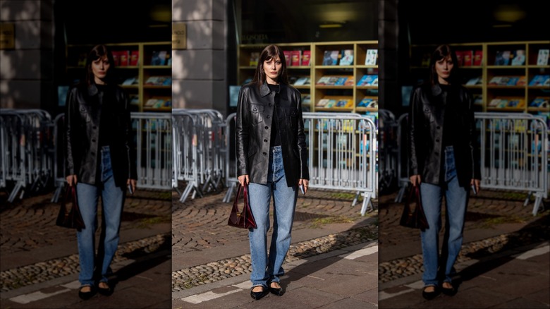 woman wearing leather coat and flats