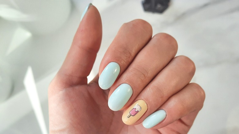 Manicure with mint green polish and ice cream art