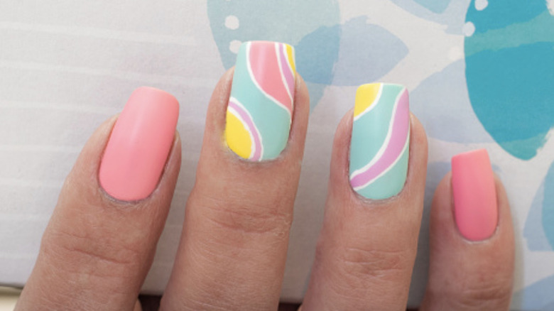 Manicure with two pink nails and two designed nails