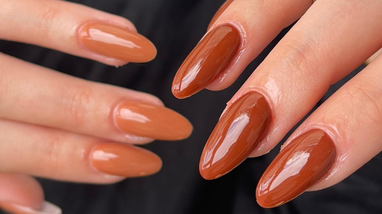 Left hand with caramel nails right hand with cognac brown nails