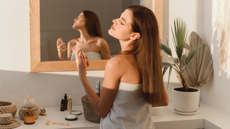 Woman applying perfume