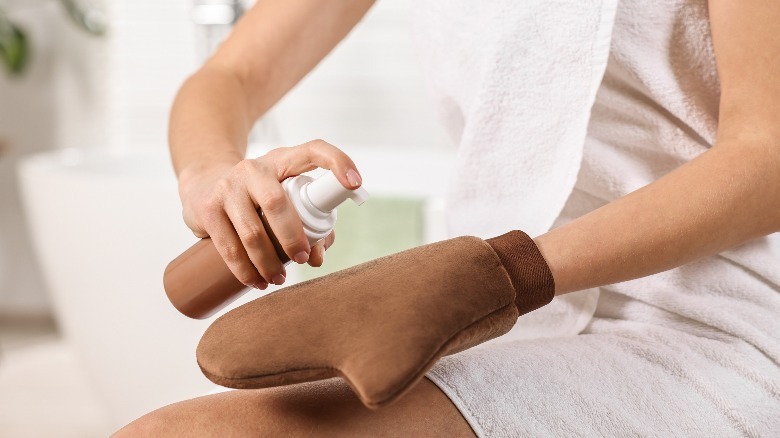 woman using self-tanner