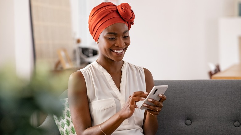 woman typing on phone