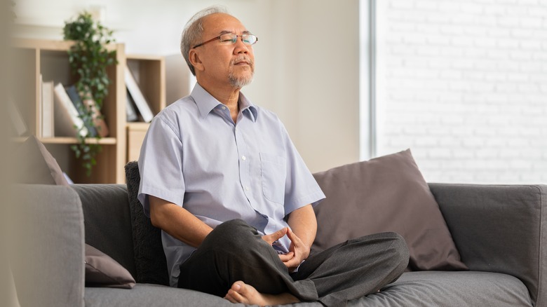 Man sitting on sofa in meditation