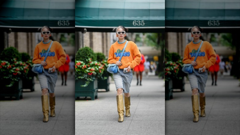 woman wearing denim bermuda shorts and sweater