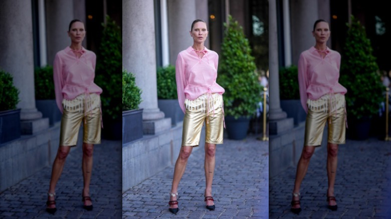 woman with gold metallic bermuda shorts