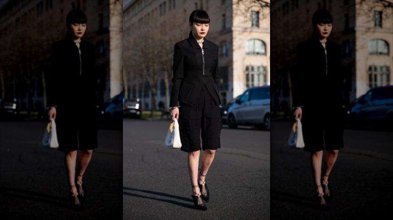 woman wearing all black outfit with bermuda shorts