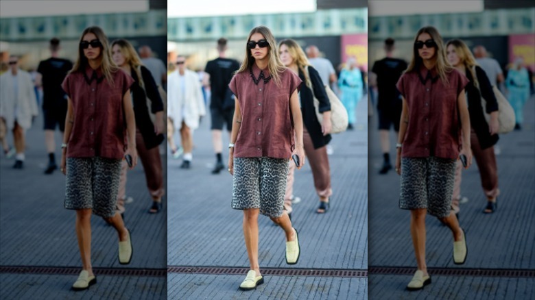 woman wearing leopard bermuda shorts and top