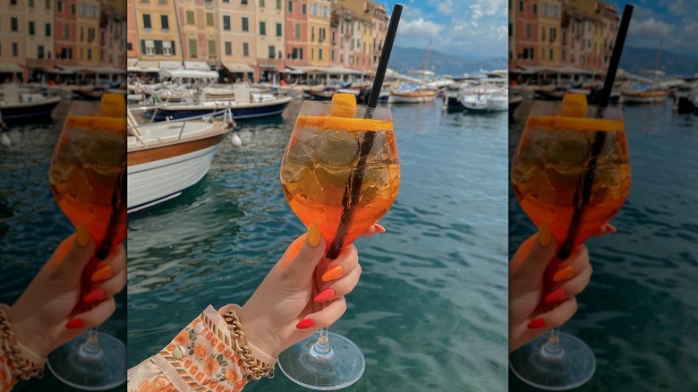 woman holding drink outside