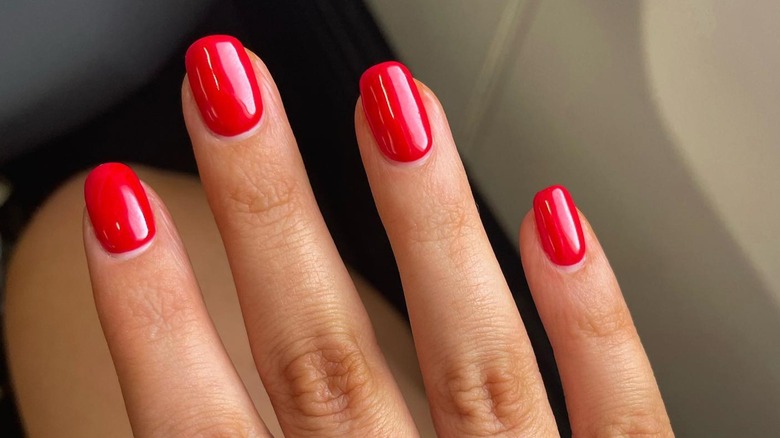 hand with red squoval nails