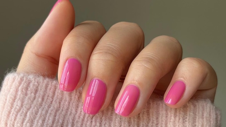 hand with barbie pink squoval nails