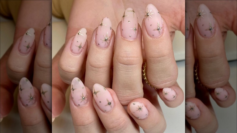 woman with glitter starburst nails