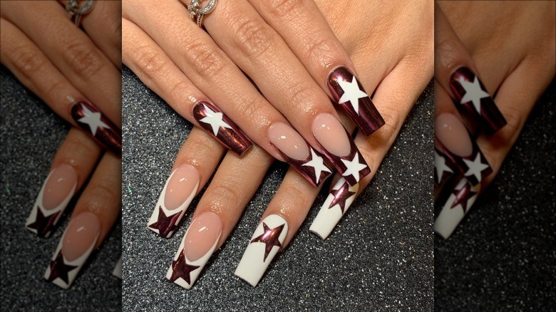 woman with white and copper star nails