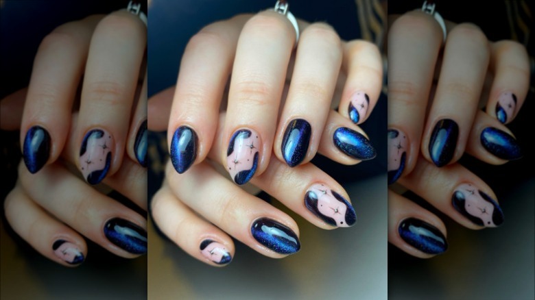 woman with dark blue star nails