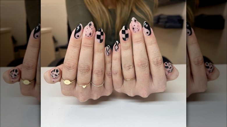 woman with black and clear star nails