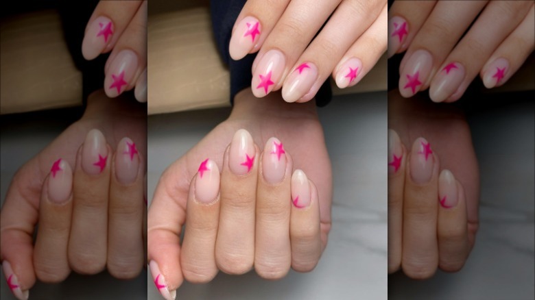 woman with pink star nails