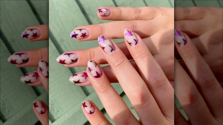 woman with pink star nails