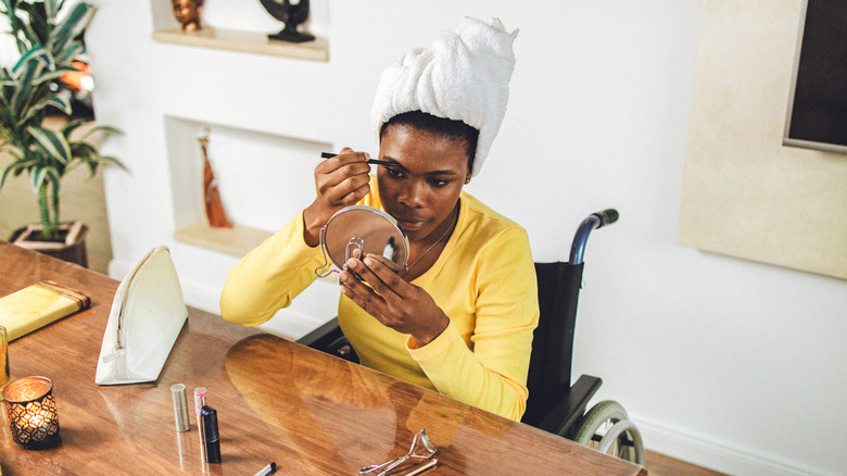 Woman applying eyebrow makeup