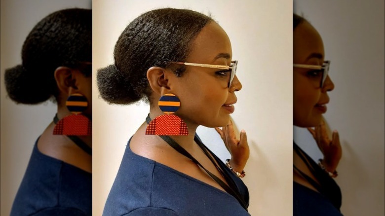 A woman wearing geometric retro earrings